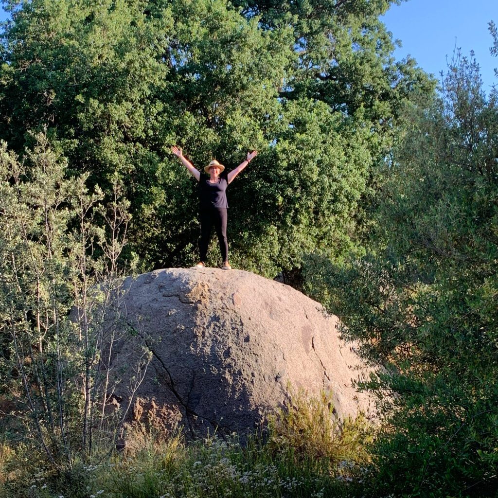 Chef Virginia Willis on top of a boulder